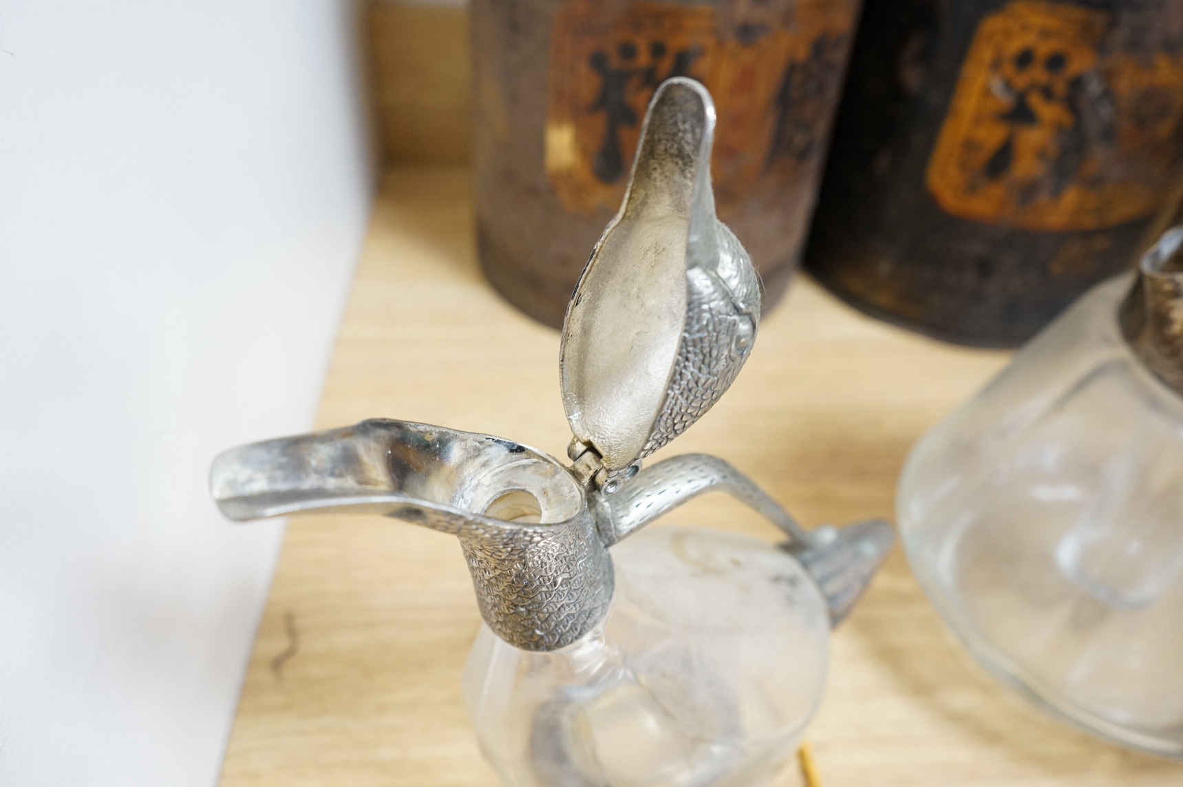 Silver plated ware to include a plated novelty duck decanter and two entree dishes and covers. Condition - fair